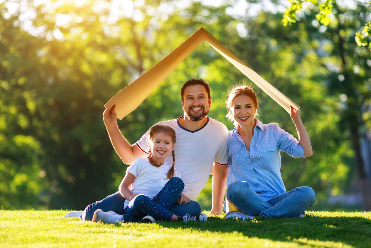 concept of mortgage and housing for   families. mother father and child from   roof of   house on   nature