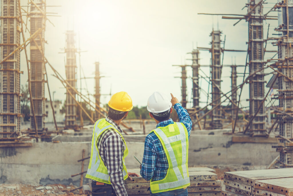 Two young man architect on a building construction site