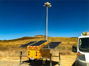 Solar-powered mobile security trailer showing solar panel array and four-camera surveillance system at Castaic remote site