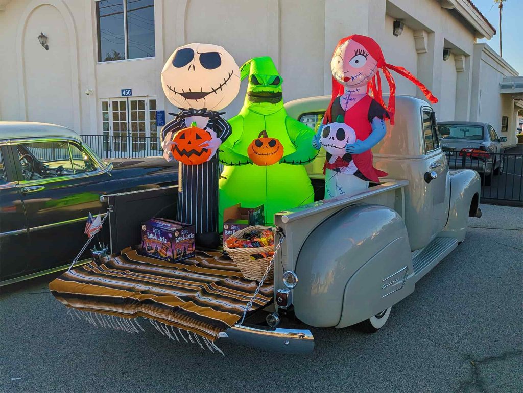 Decorated vintage Chevrolet with large skeleton display colorful mat Valley Alarm Trunk-or-Treat 2025.