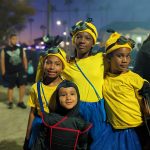 Four siblings in matching yellow Minion costumes with goggles and overalls at Valley Alarm Trunk-or-Treat San Fernando 2025