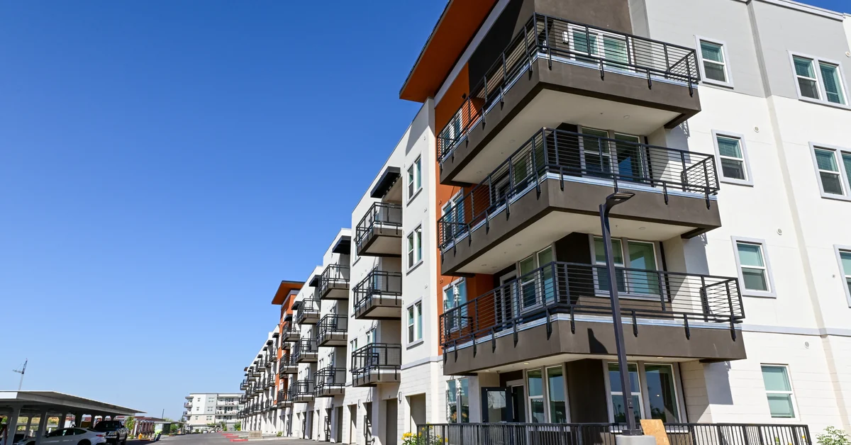 Multi-story apartment complex with balconies, surface parking, and a fire lane covered by remote video monitoring