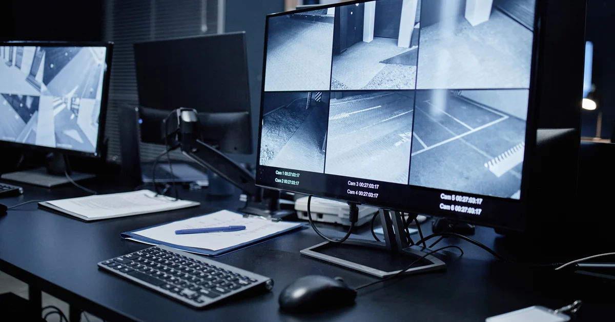Monitoring center workstation showing multiple live security camera feeds on screen