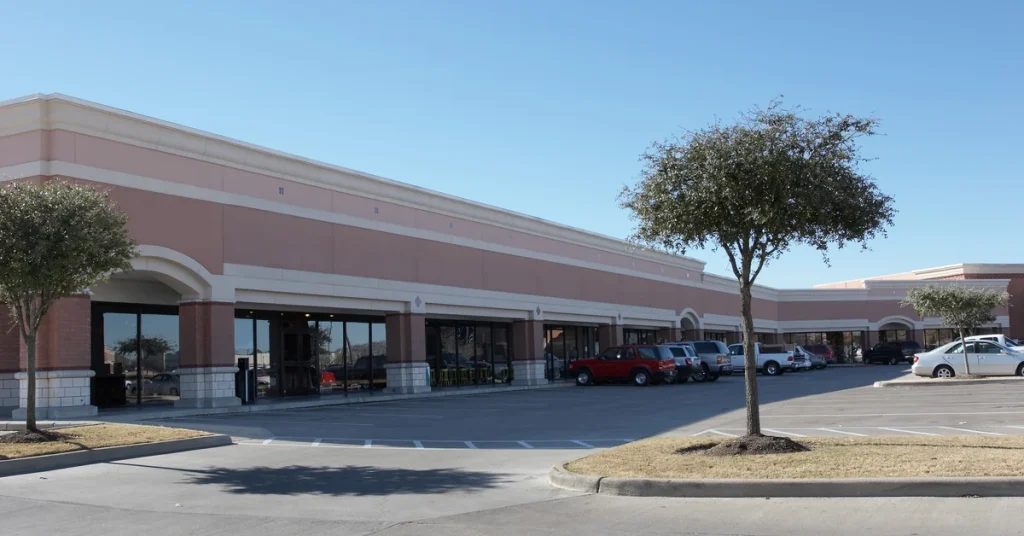 Retail strip center storefronts and parking lot covered by live video monitoring
